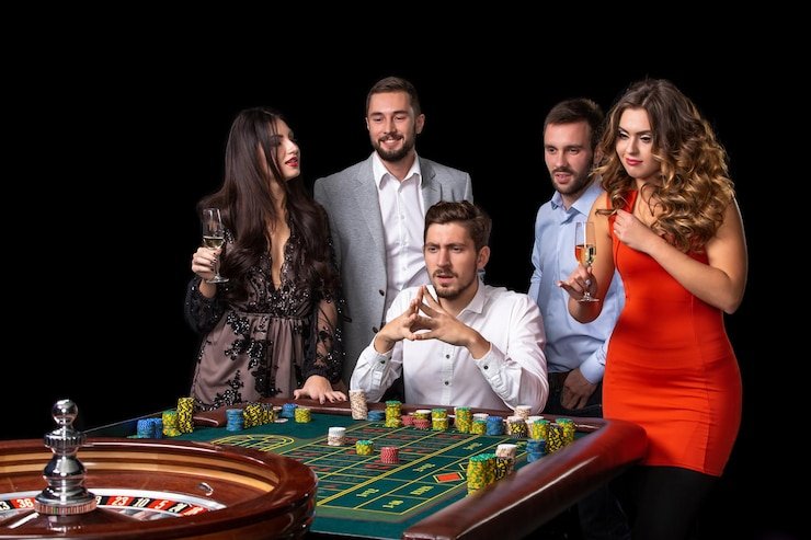 Phone screen showing studio lobby with table filters, betting buttons, and live video feed